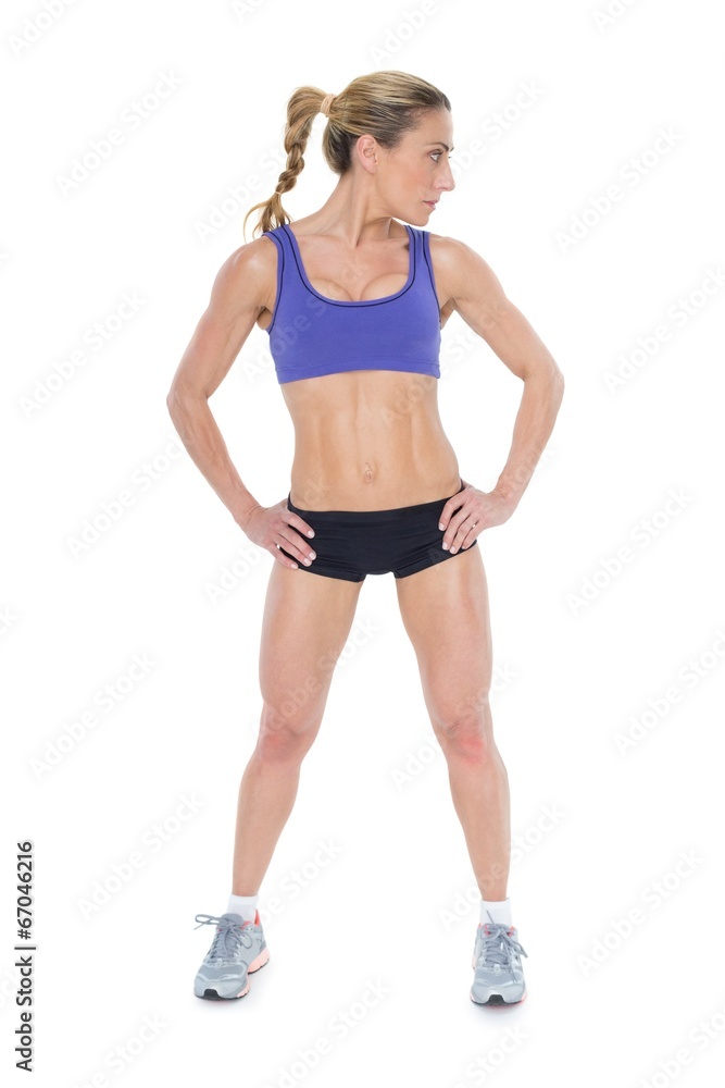 Strong blonde posing with hands on hips Strong blonde posing with hands on hips