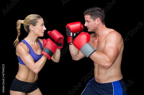 Bodybuilding couple posing with boxing gloves © WavebreakmediaMicro