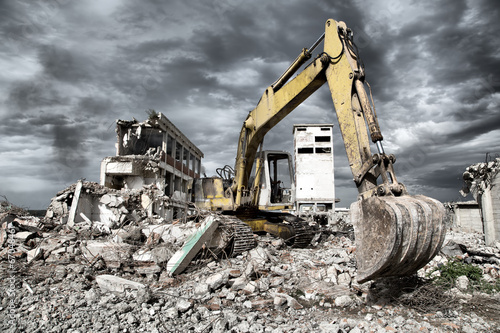 Fotografie, Obraz Bulldozer removes the debris from demolition of old buildings