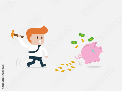 Business man breaking piggy bank with coins.