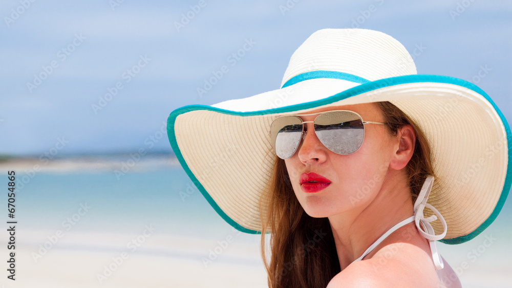 beautiful woman with red lips in sun hat.