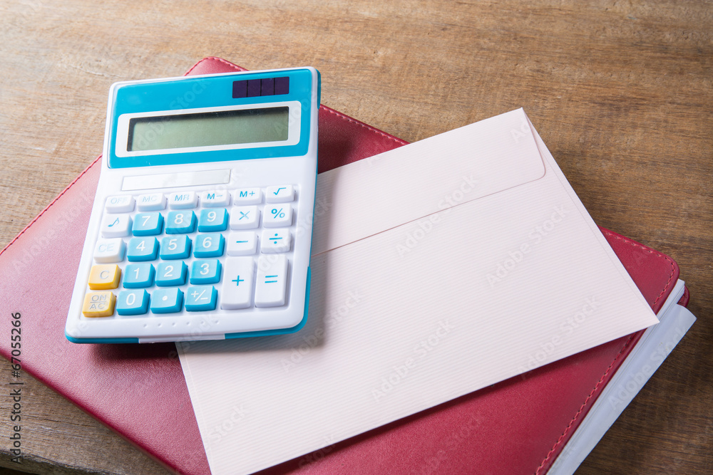Notebook, calculator, letter on table wood