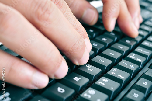 Картината върху платно typing on a computer keyboard