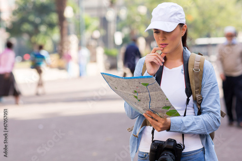 tourist on the street looking at a map