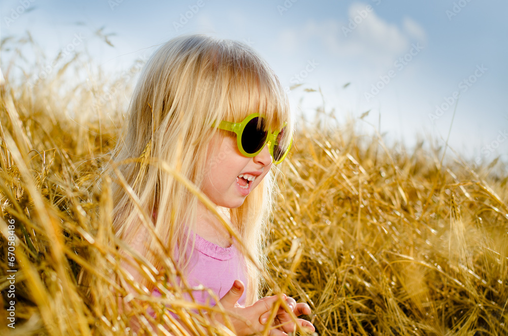 Cute little girl wearing sunglasses, in a warm day Cute little girl wearing sunglasses, in a warm day