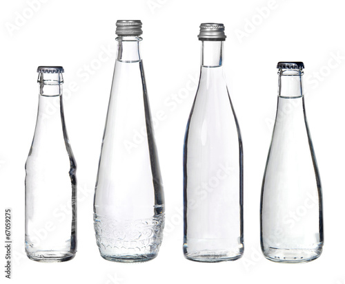 glass bottles with water isolated on white