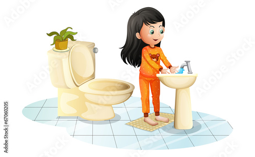 A cute little girl washing her hands