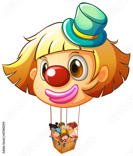 A big clown balloon with a basket full of happy kids