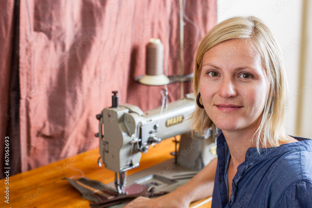 Smiling Blonde Woman At Sewing Machine