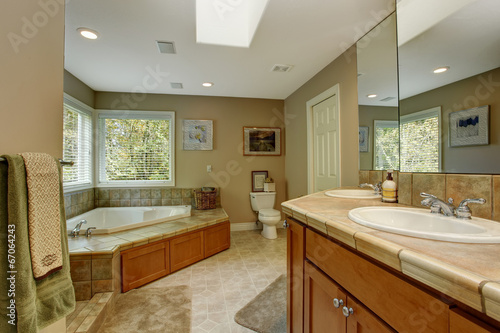 Spacious bathroom with corner bath tub