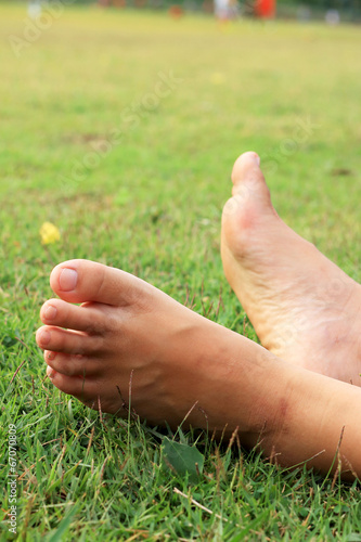 Barefoot on a green lawn. © oilslo