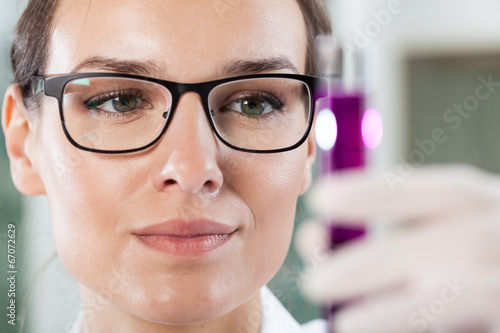 Close-up of a woman holding a test tube