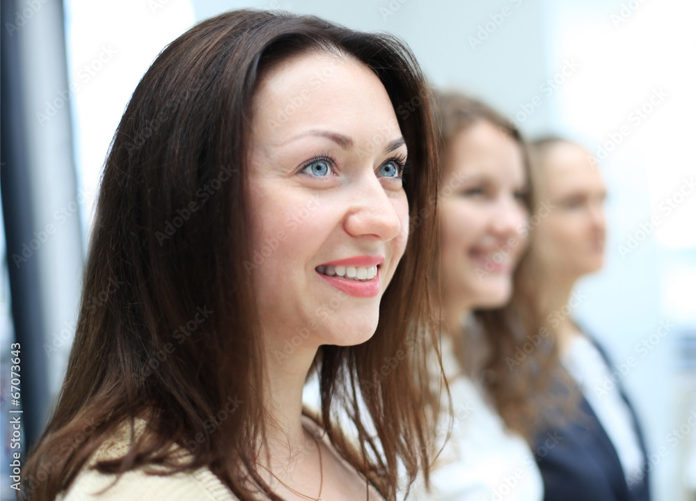 business team standing in a row at office and looking upwards business team standing in a row at office and looking upwards