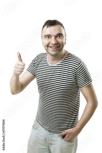 Fotografie Glad tall guy showing thumbs up sign. like it!