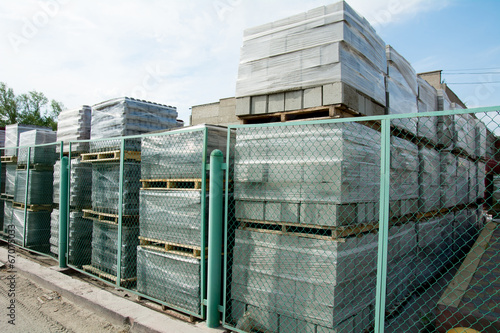 Packed cinder blocks outdoors in racks.