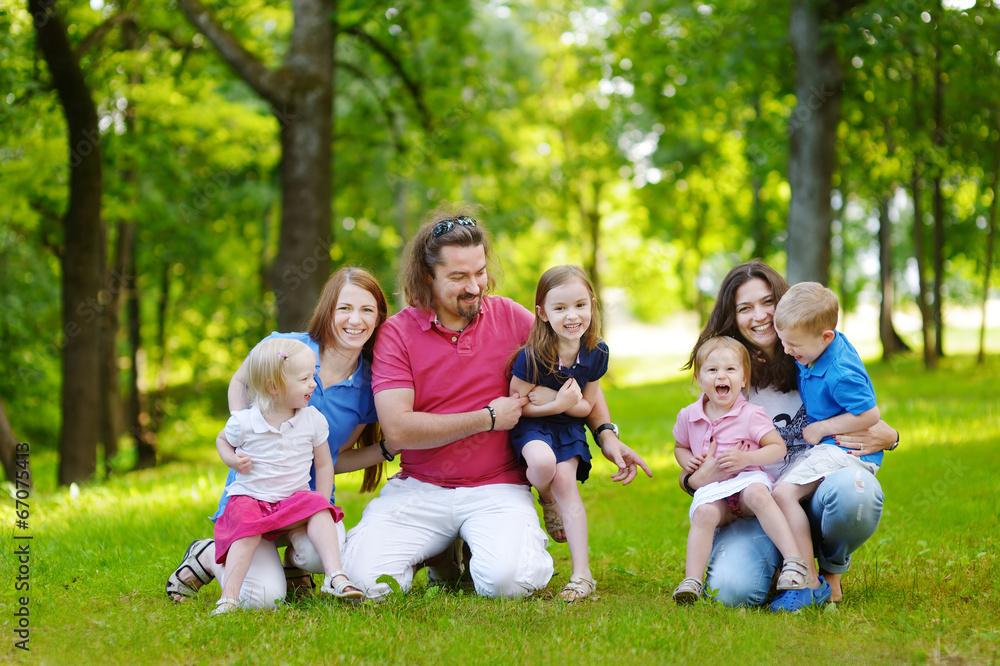 Happy big family having fun in summer park