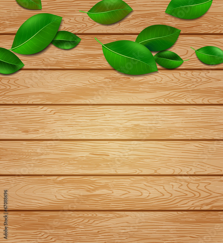 wooden background with green leaves