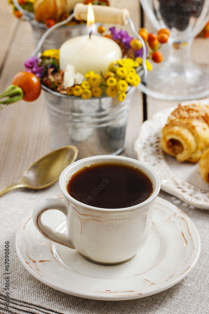 Breakfast table: cup of coffee and buns with chocolate Breakfast table: cup of coffee and buns with chocolate