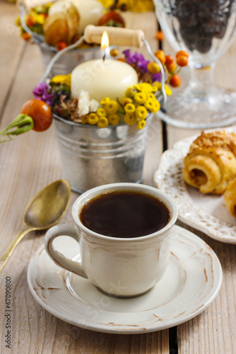 Breakfast table: cup of coffee and buns with chocolate