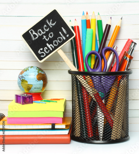 School-office stationery on book background .