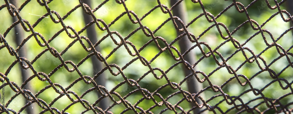 Detail of an old rusting chain fence Detail of an old rusting chain fence