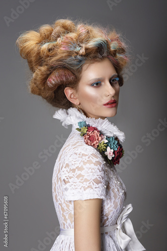 Updo. Dyed Hair. Woman with Modern Hairstyle. High Fashion photo