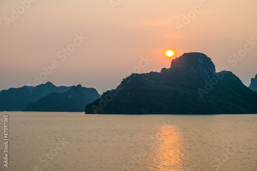 Sunset over mountains and sea in Halong Bay