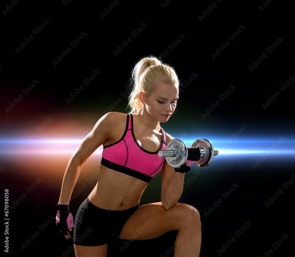 young sporty woman with heavy steel dumbbell young sporty woman with heavy steel dumbbell