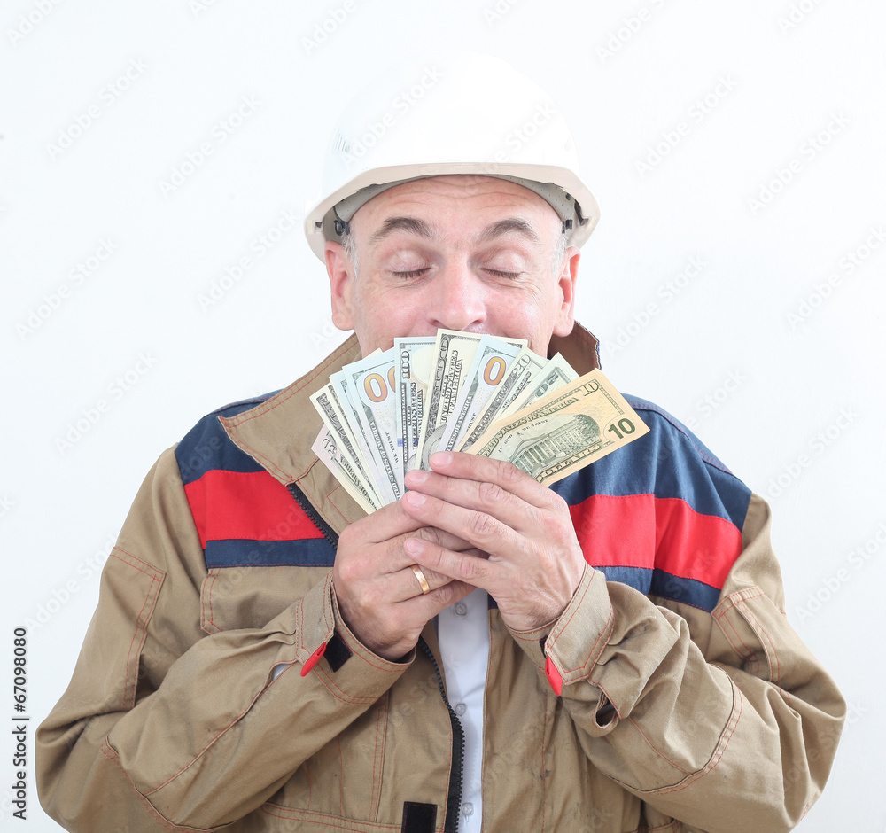 man in uniform with white construction helmet and holding money man in uniform with white construction helmet and holding money