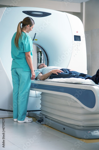 Картината върху платно Open MRI scanner with man in 40s undergoing test