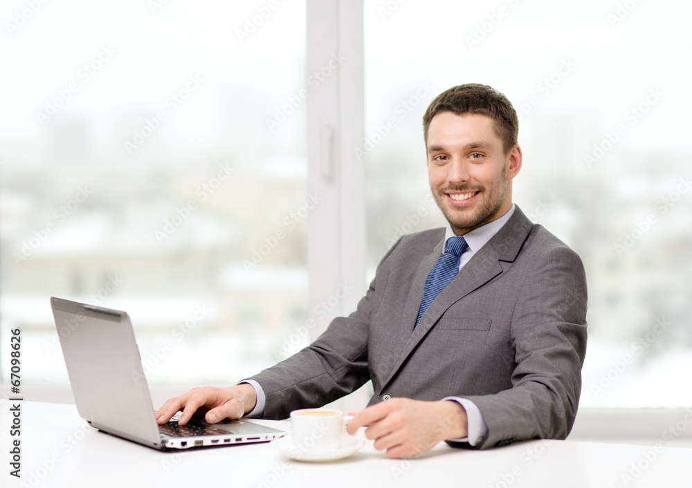 smiling businessman with laptop and coffee smiling businessman with laptop and coffee