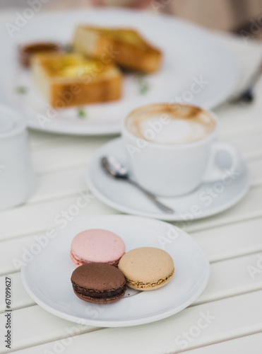 breakfast with cheesecakes, toast, cappuccino and macarons