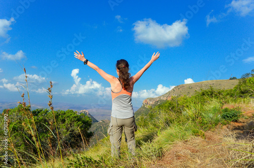 Woman trekking in mountains  hiking tourist looking at view
