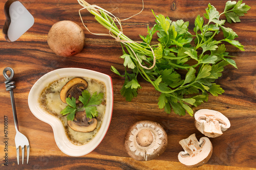 Mushroom casserole with fresh parsley  on wooden  background