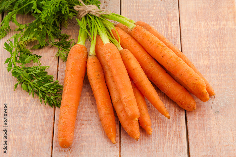 Fresh organic carrots with their tops Fresh organic carrots with their tops
