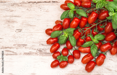 cherry tomatoes and basil leaves. food background