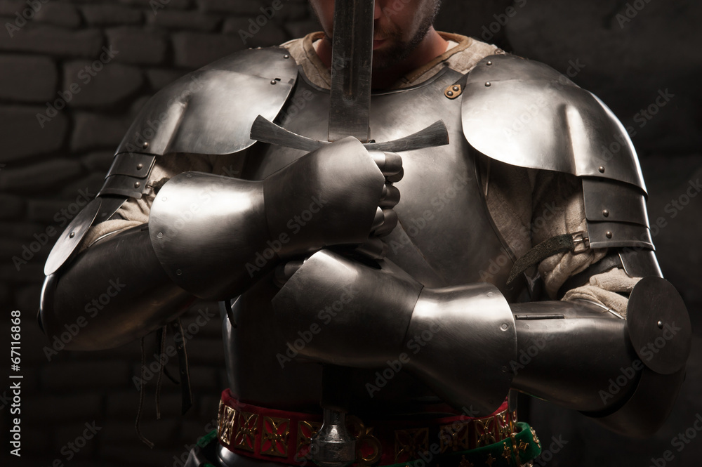 Medieval knight kneeling with sword Stock Photo Adobe Stock