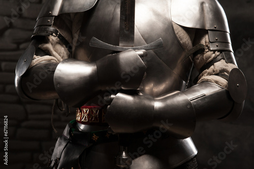Fotografering Closeup portrait of medieval knight in armor holding a sword
