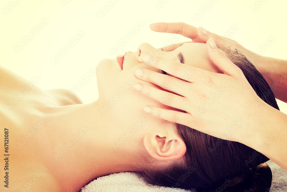 Fototapeta premium Relaxed woman enjoy receiving face massage