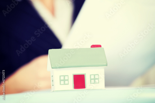 Business woman with small house.