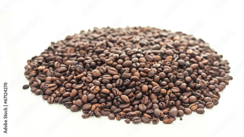 Heap of roasted coffee beans being rotated on white background Heap of roasted coffee beans being rotated on white background