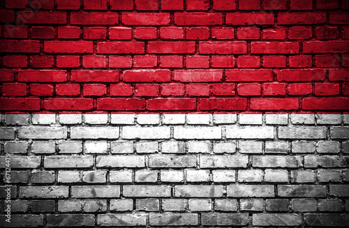 Brick wall with painted flag of Monaco
