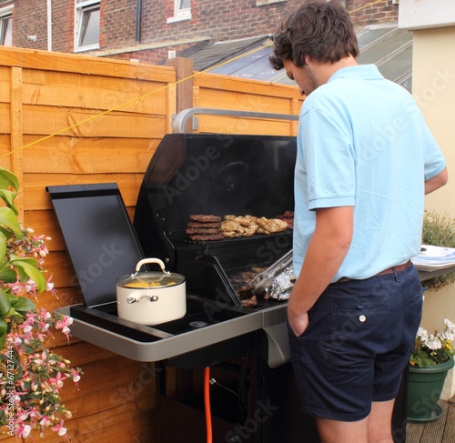 A young man cooking on the bbq