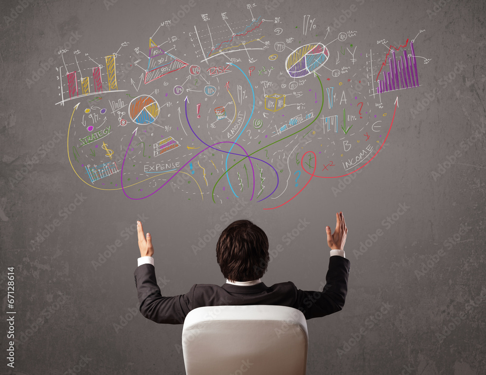 Young business man looking at sketches of graphs and symbols Young business man looking at sketches of graphs and symbols
