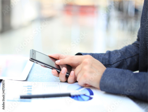 Close up of a business woman using mobile smart phone