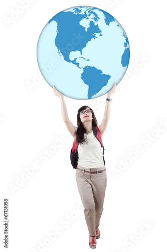 Casual student is holding globe