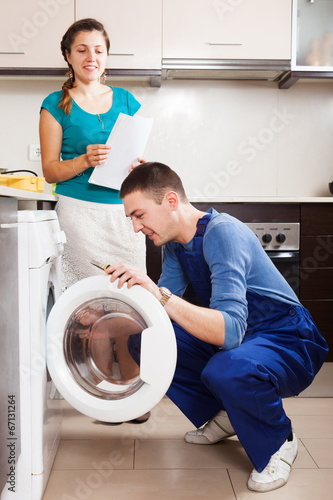 Repairman repairing a washing machine
