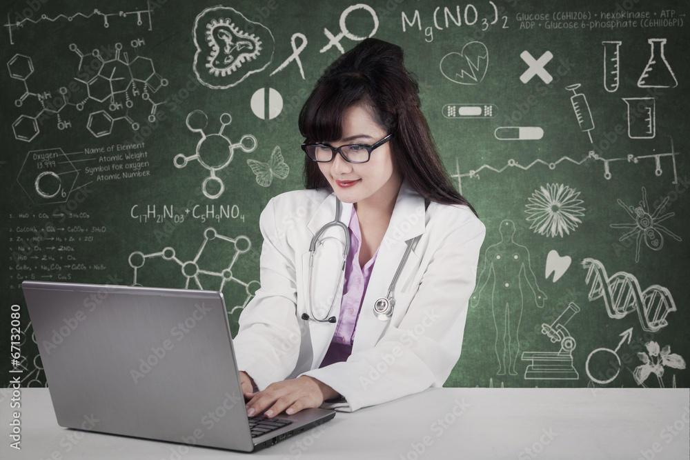 Doctor working on laptop in laboratory Doctor working on laptop in laboratory