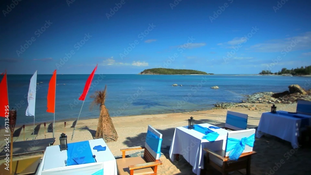 Beach restaurant with sea view and waving flags. Koh Samui
