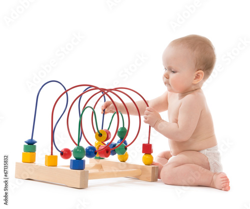 Infant child baby toddler standing and playing wooden educationa photo